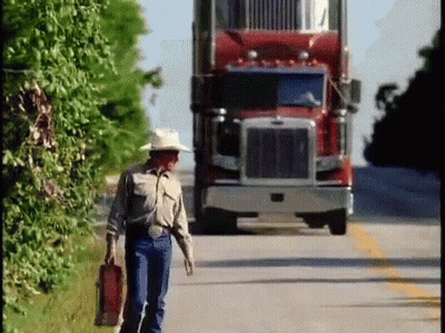 Man In Cowboy Hat Walking In Front Of Red Semi Truck GIF
