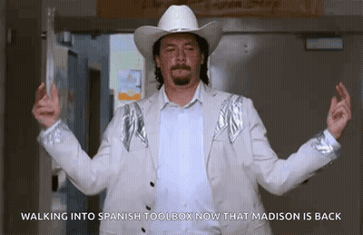 Man In Cowboy Hat Walking Into Spanish Toolbox After Madison Back GIF