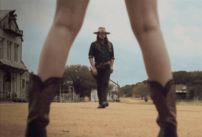 Man In Cowboy Hat Walking With Woman In Cowboy Boots GIF