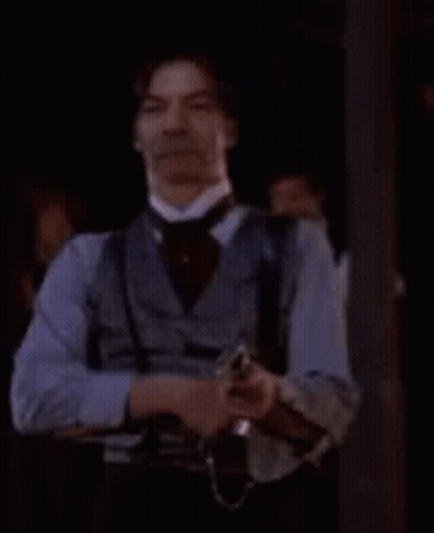 Man In Cowboy Outfit Holding Gun GIF