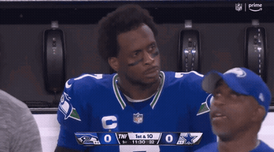 Man In Cowboys Jersey Looking At Scoreboard GIF