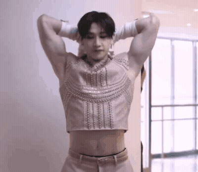 Man In Crop Top And Gloves Hands Behind Head GIF