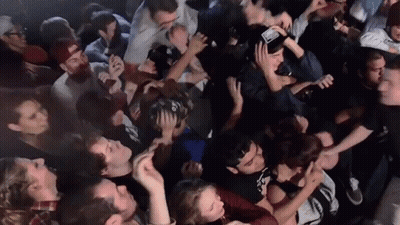 Man In Crowd Wearing I Love You Hat GIF