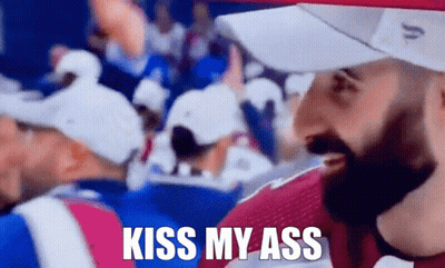 Man In Crowd With Kiss My Ass Shirt GIF
