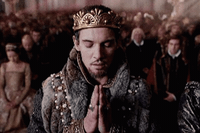Man In Crown And Fur Coat Praying Before Crowd GIF