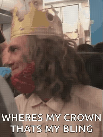Man In Crown And Red Bandana On A Plane GIF