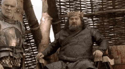 Man In Crown Sitting Next To Another Man GIF