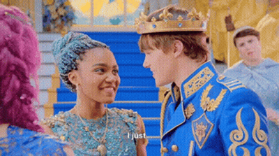 Man In Crown Talking To Woman In Blue Dress GIF