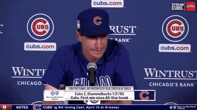 Man In Cubs Hat Sitting At Microphone GIF