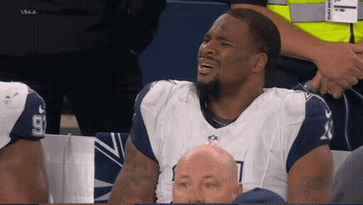 Man In Dallas Cowboys Uniform Sitting In Stands GIF