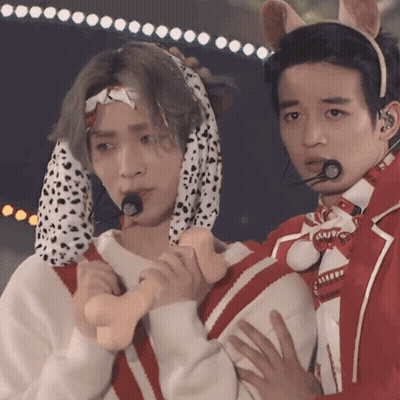 Man In Dalmatian Costume Holding Another Man's Hand GIF