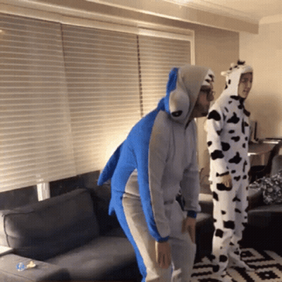 Man In Dalmatian Costume Next To Shark Costume GIF