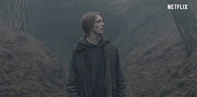 Man In Dark Forest With Netflix Logo GIF