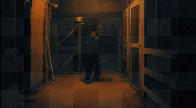 Man In Dark Hallway Wearing Skeletons Shirt GIF
