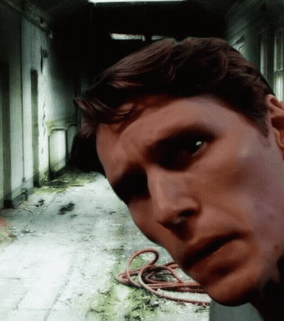 Man In Dark Hallway With Hose On Floor GIF