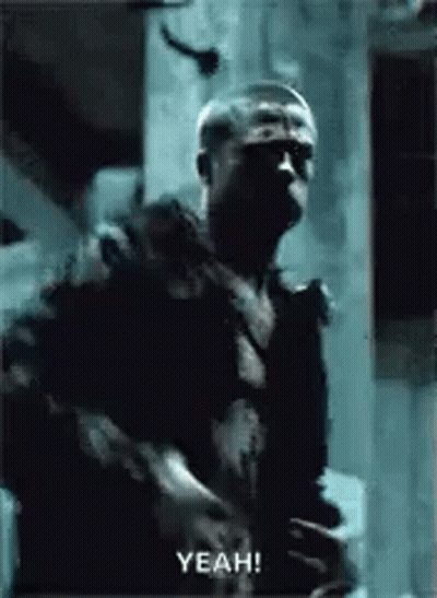 Man In Dark Room Holding Gun Saying Yeah GIF