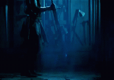 Man In Dark Room Holding Sword GIF