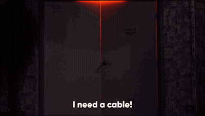 Man In Dark Room Saying I Need A Cable GIF
