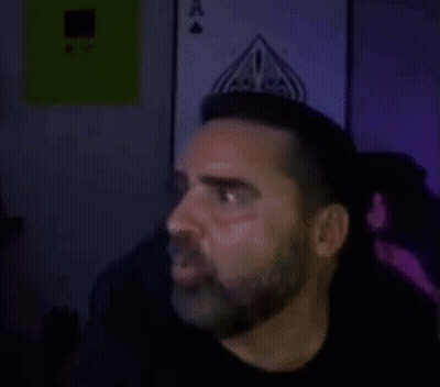 Man In Dark Room With Bayonne GIF