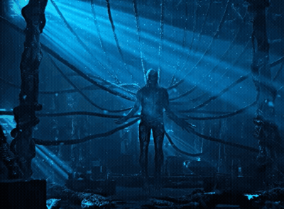 Man In Dark Room With Blue Light Through Ceiling GIF