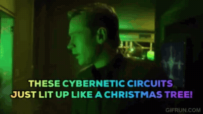 Man In Dark Room With Christmas Tree Says These Cybernetic Circuits Just Lit Up GIF