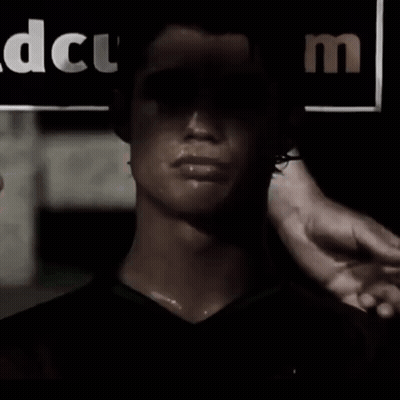 Man in Dark Room With DCUM Sign