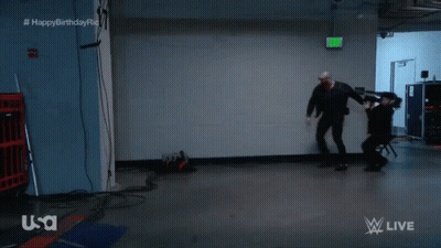 Man In Dark Room With Green Exit Sign GIF