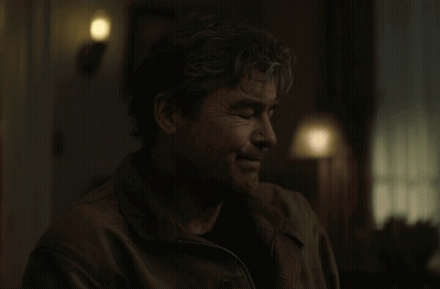 Man In Dark Room With Lamp Behind GIF