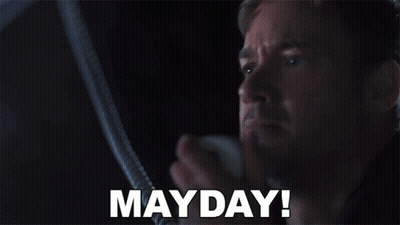 Man In Dark Room With Mayday On Face GIF