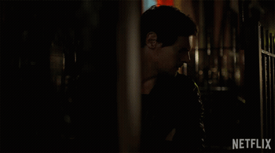 Man In Dark Room With Netflix Logo GIF