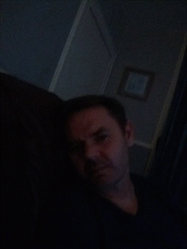 Man In Dark Room With Picture GIF