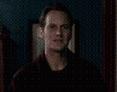 Man In Dark Room With Picture On Wall GIF