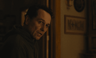 Man In Dark Room With Picture Saying A + GIF