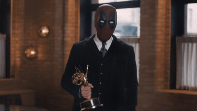 Man In Deadpool Mask Holding Trophy GIF