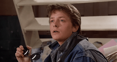 Man In Denim Jacket Holding Sunglasses GIF