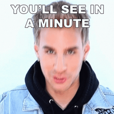 Man In Denim Jacket Making Funny Face Saying You'll See In A Minute GIF