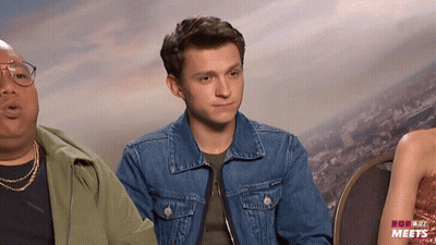 Man In Denim Jacket Next To Woman In Red Dress GIF