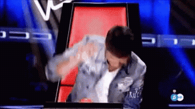 Man In Denim Jacket Sitting On Red Chair On TV Show GIF