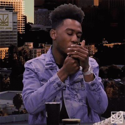 Man In Denim Jacket Smoking Cigarette GIF