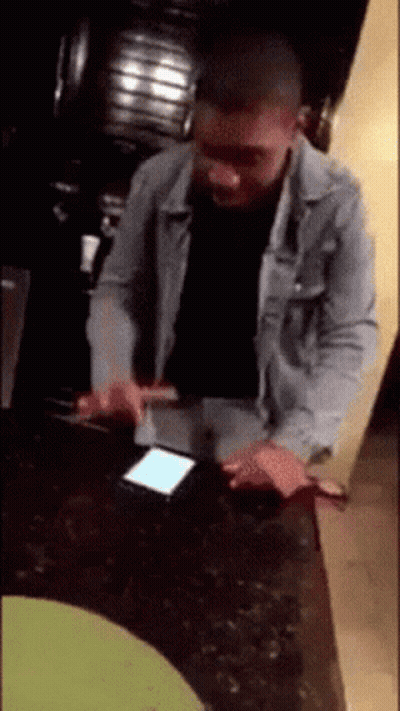 Man In Denim Jacket Using Phone GIF