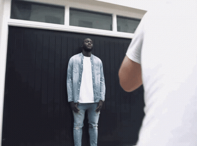 Man In Denim Shirt At Garage Door GIF