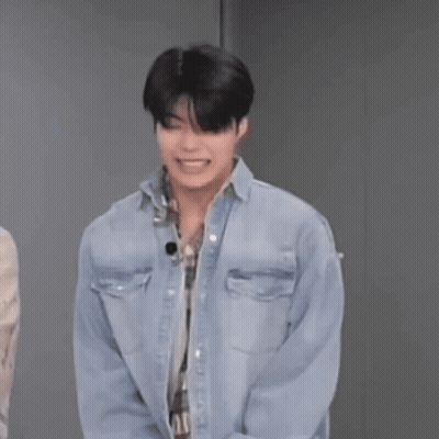 Man In Denim Shirt Laughing Hands Behind Back GIF