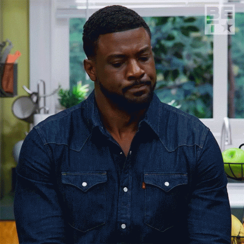 Man In Denim Shirt Looking Down GIF