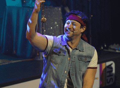 Man In Denim Vest Holding Pendant GIF
