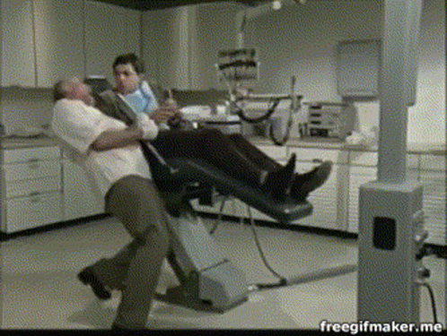 Man In Dental Chair Held By Another Man Freegifmaker.me GIF