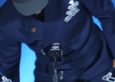 Man In Denver Broncos Hat In Front Of NFL Logo GIF