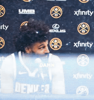 Man In Denver Jersey In Front Of Xfinity Banner GIF