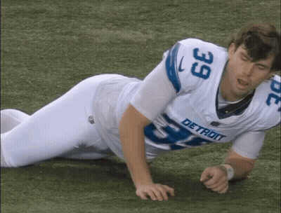 Man In Detroit Jersey Laying On Grass GIF