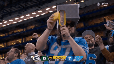 Man In Detroit Lions Jersey Holding Yellow Object GIF