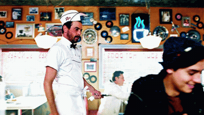 Man In Diner Wearing Hat Saying R.I GIF